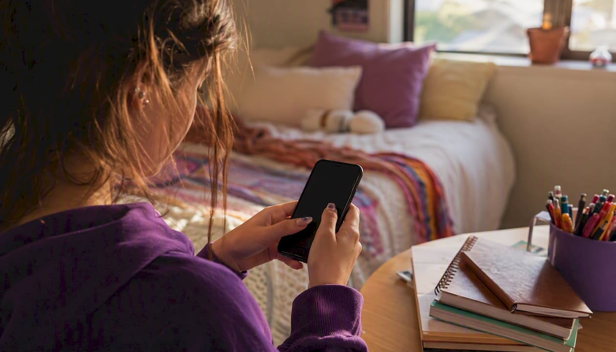 Hands using period tracking app on smartphone