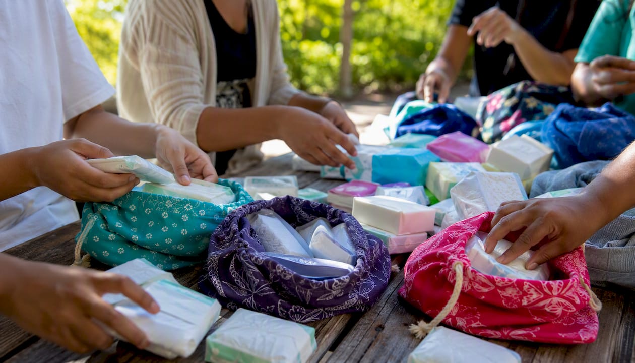 Volunteers sorting menstrual donation supplies