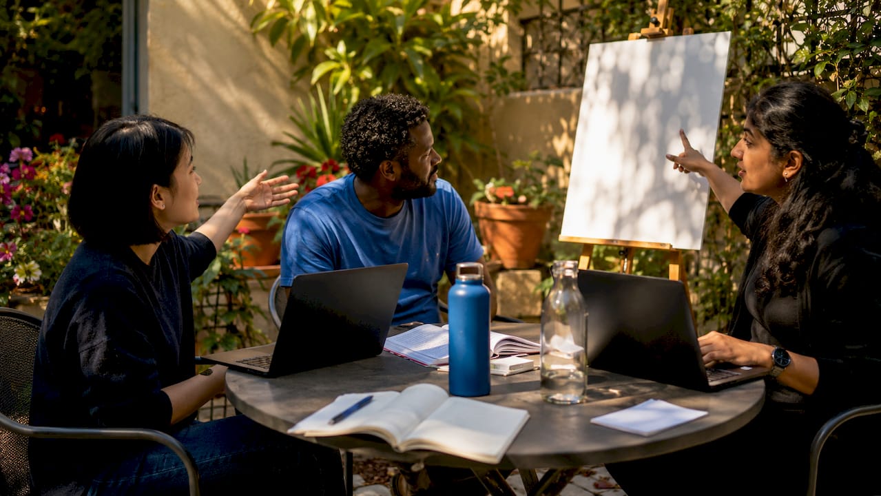 Diverse IT professionals discussing MLOps and AIOps workflows