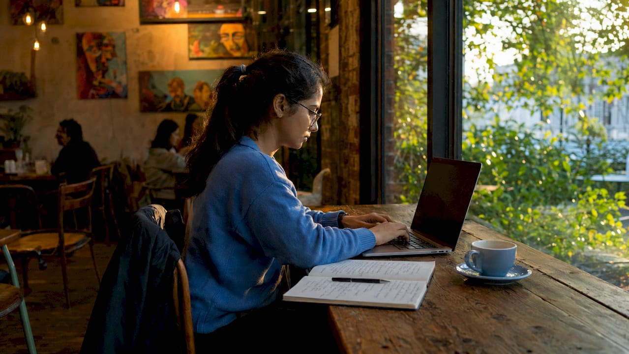 ML engineer coding on laptop in home office