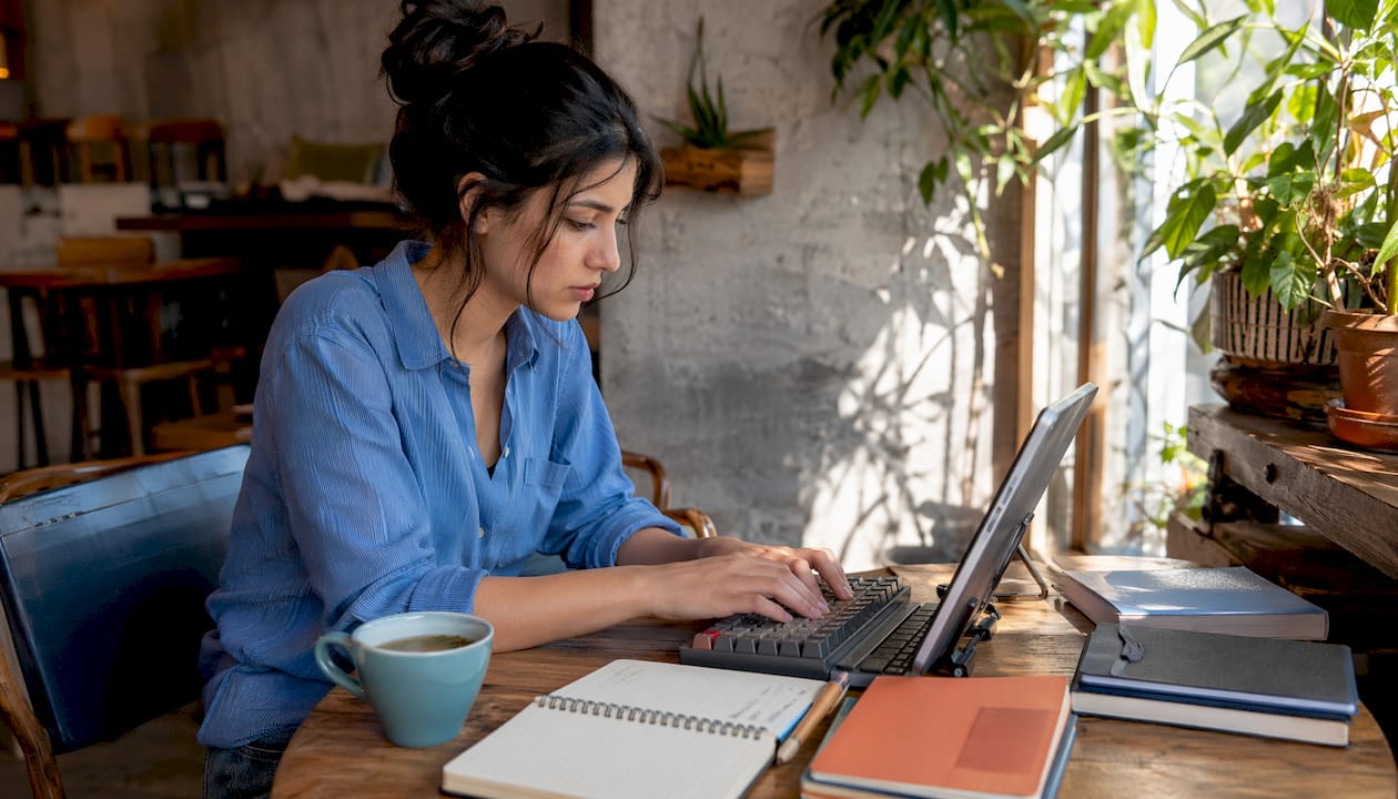 Hands typing and taking notes on evaluation techniques