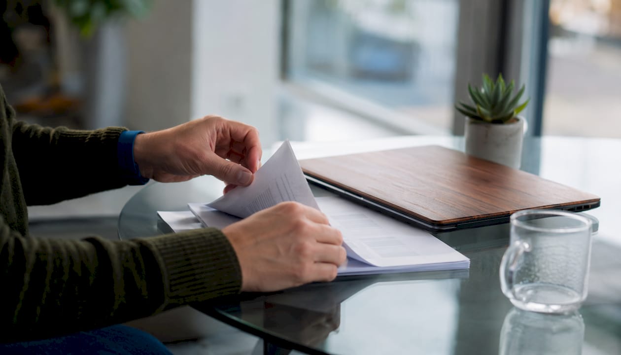 Hands marking AI governance checklist