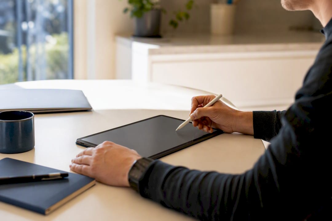 Hands annotating data on tablet