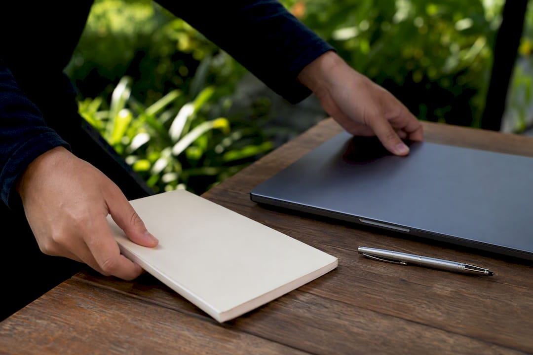 Hands arranging desk items for AI evaluation