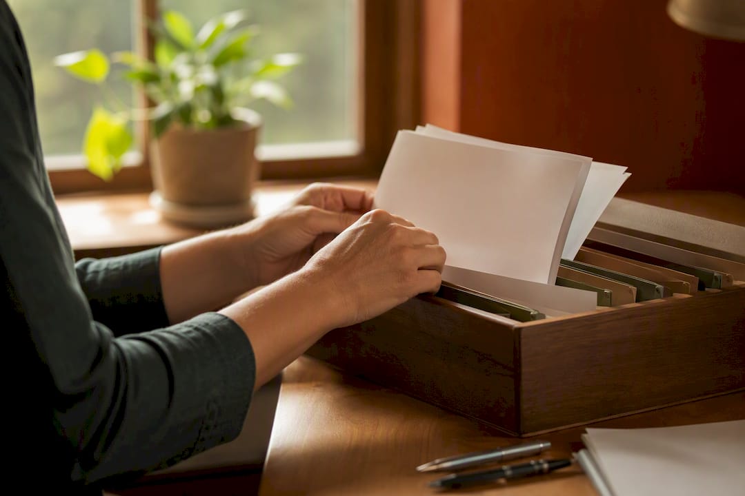 Hands sorting stacked uninsured motorist insurance papers