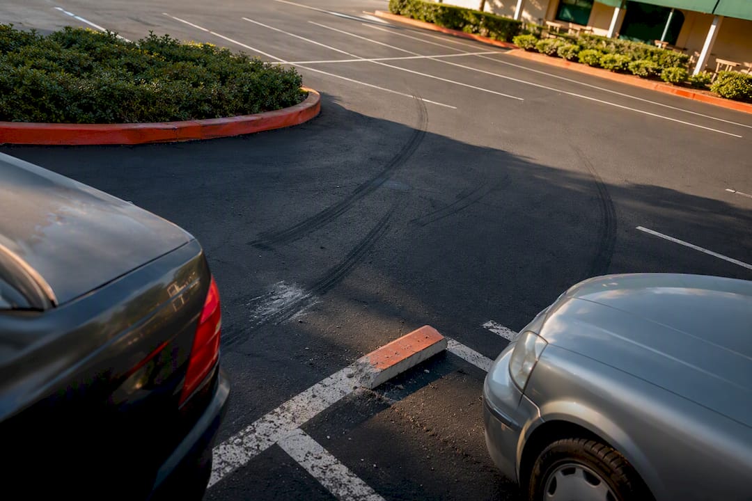 Parking lot collision scene with tire marks