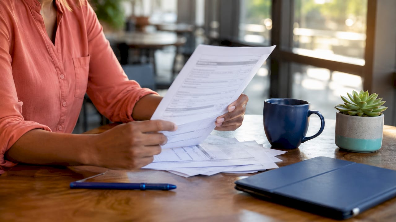Hands holding insurance reimbursement policy document
