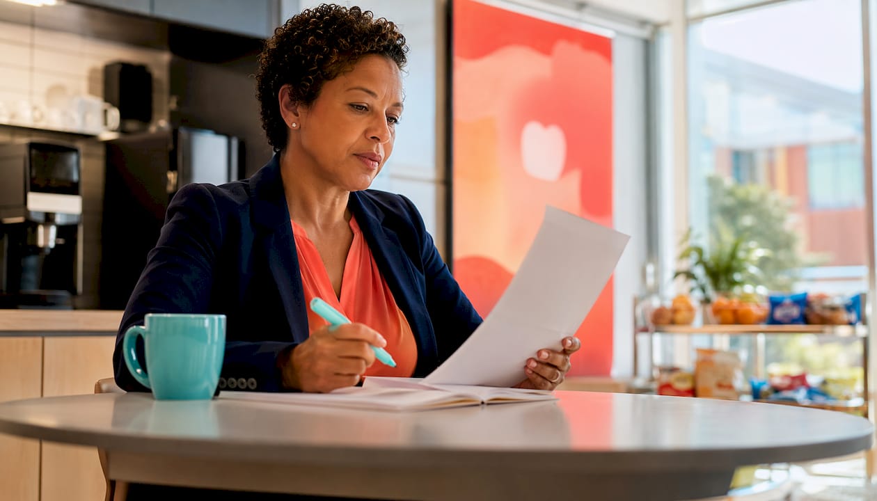 Procurement manager reviewing policy document