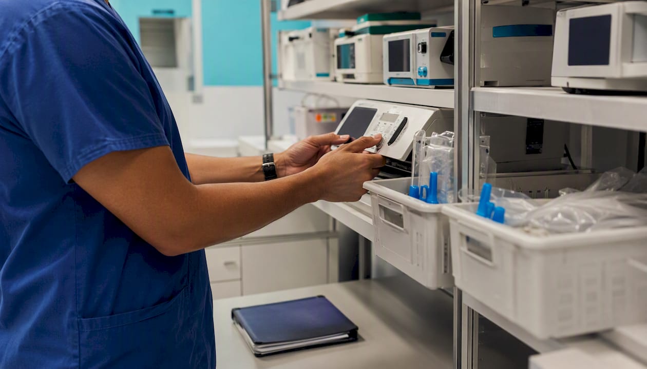 Hands inspecting medical equipment in hospital storage