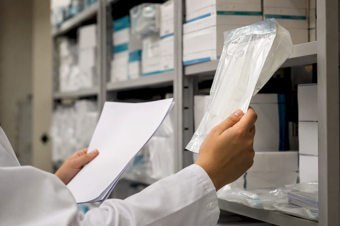 Inspector checking compliance tags on medical packaging