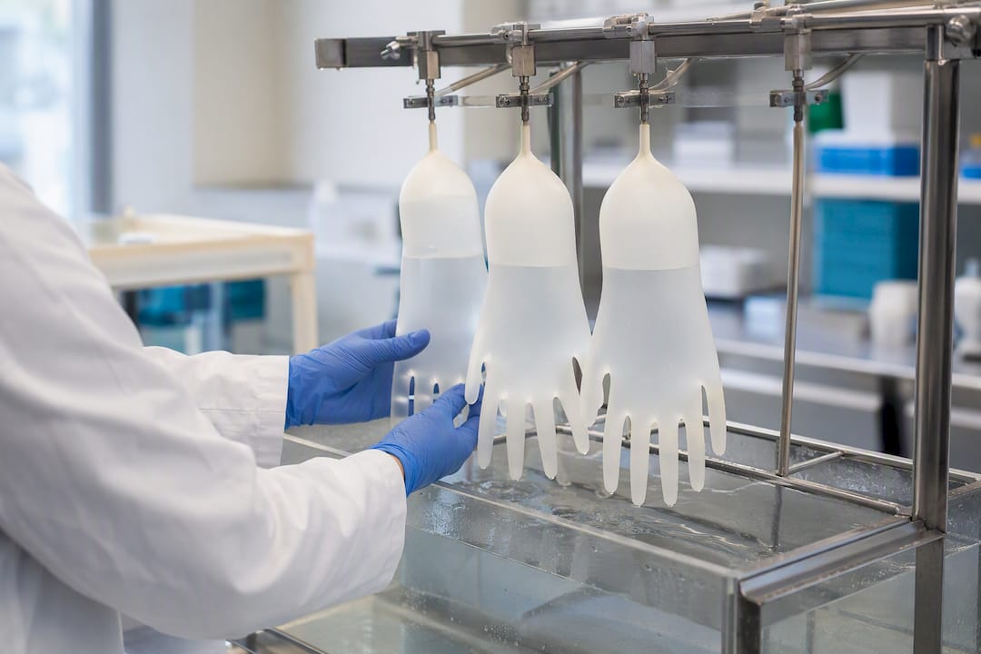 Hands testing medical gloves for leaks