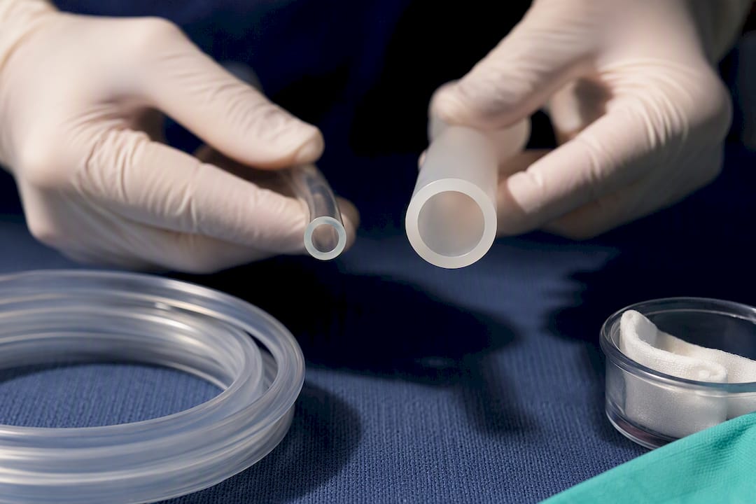 Thick suction tubing beside larger-bore catheter