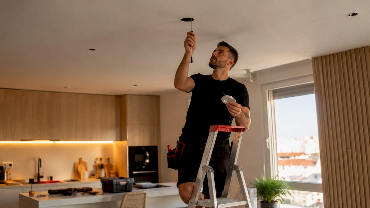 Un profesional realiza la instalación de luces LED en una vivienda de Torrevieja.