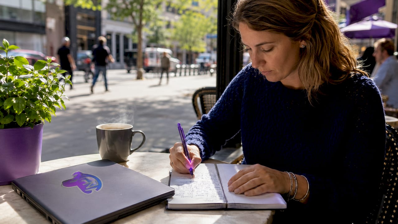 Hands writing specific nanny duties in notebook