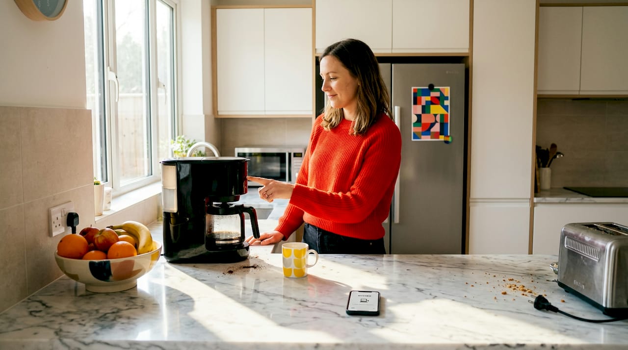 Woman using smart plug kitchen appliance