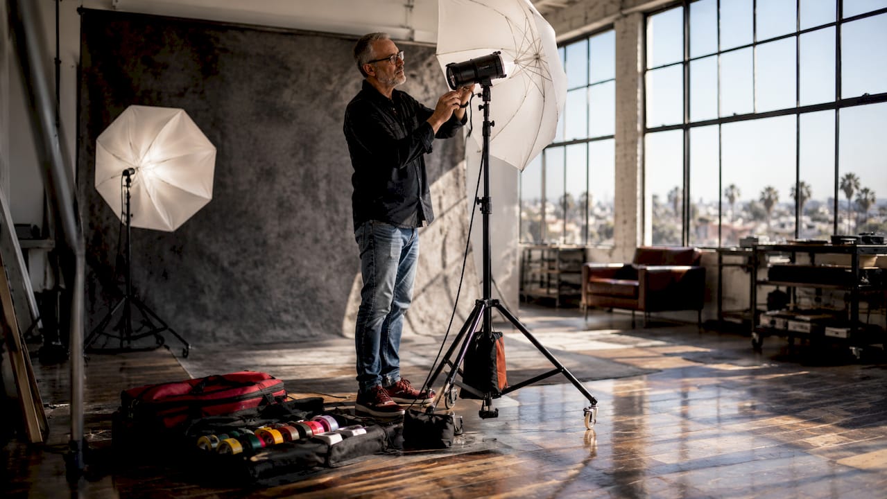 Photo studio lighting equipment setup with photographer