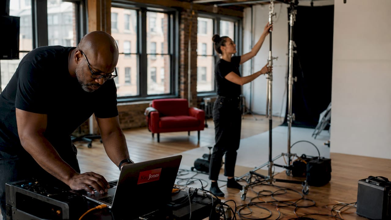 Crew preparing lighting and gear in NYC studio