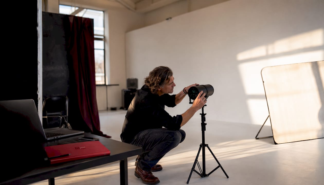Photographer adjusting studio strobe lighting