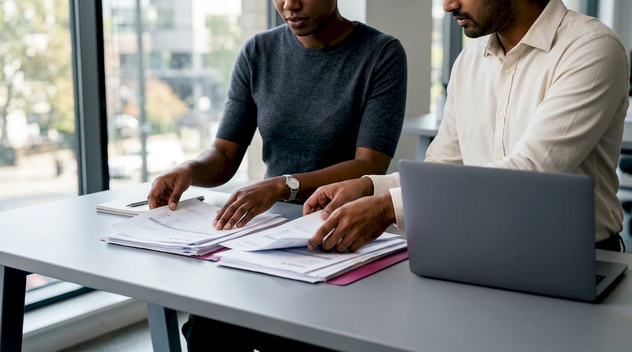 Close-up of hands reviewing business invoices