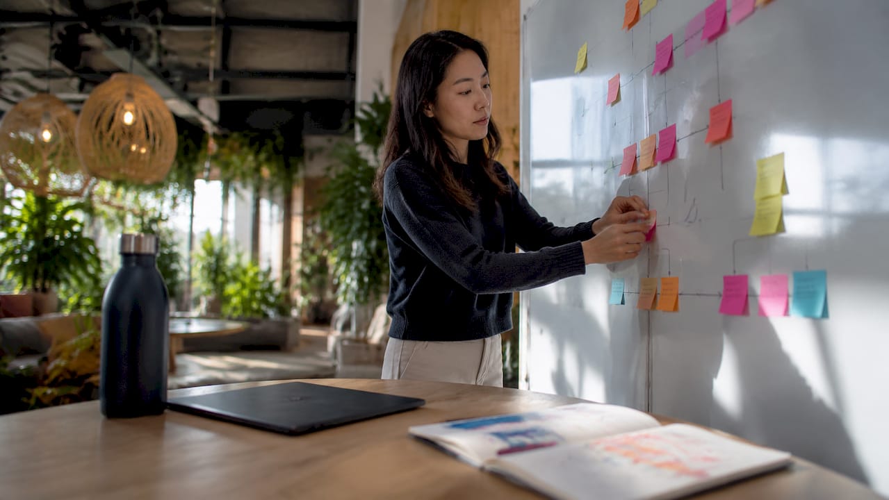 Engineer creating AI pipeline flowchart on whiteboard