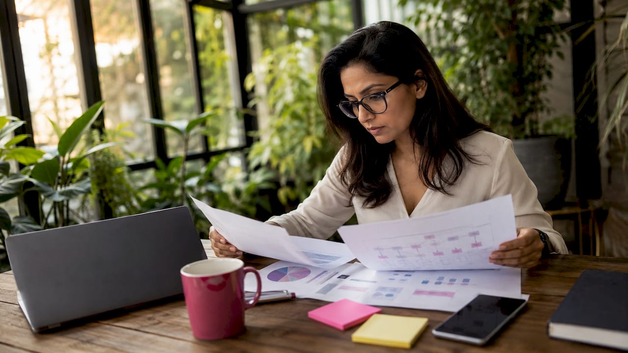 Businesswoman reviewing AI workflow papers