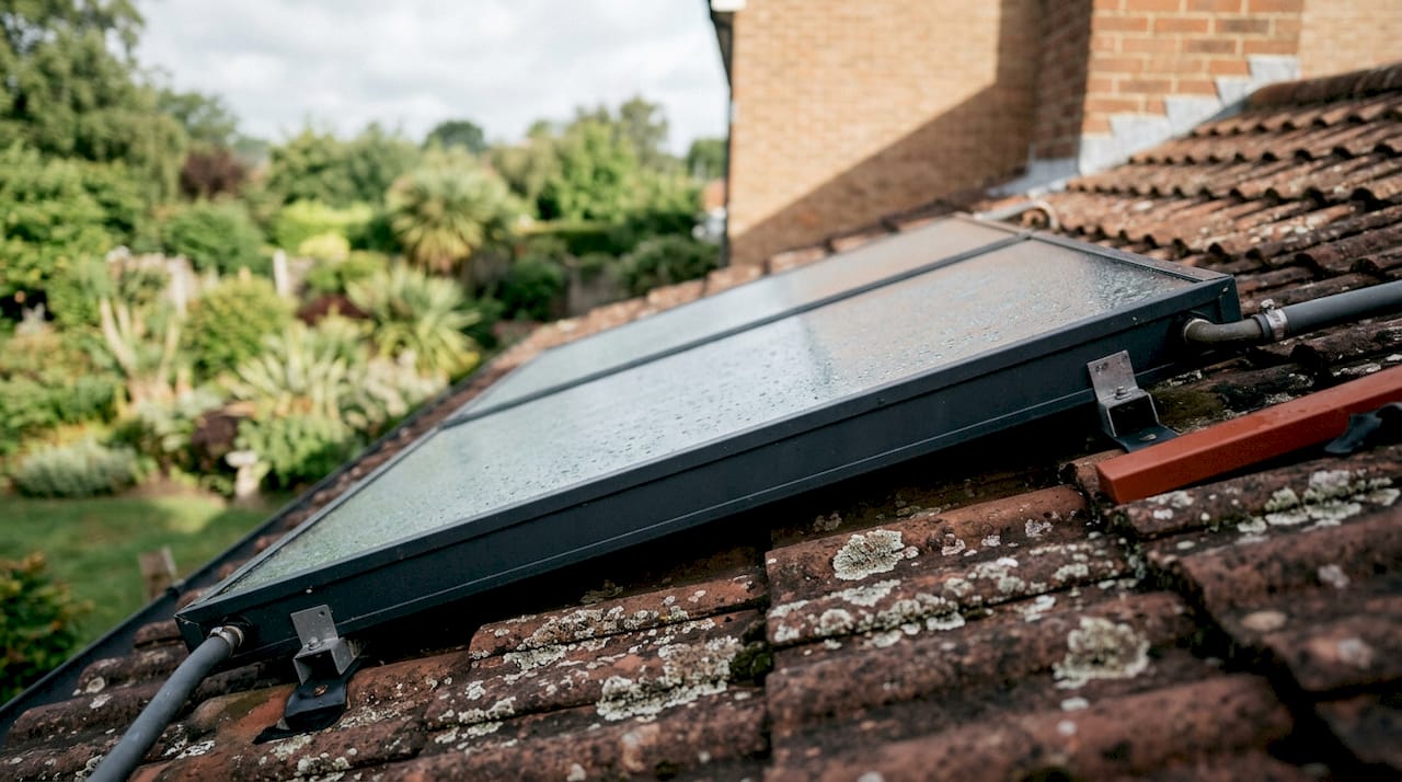 Close-up of flat plate solar water heating panel on roof