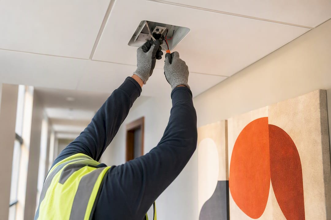 Electrician repairing emergency lighting wiring