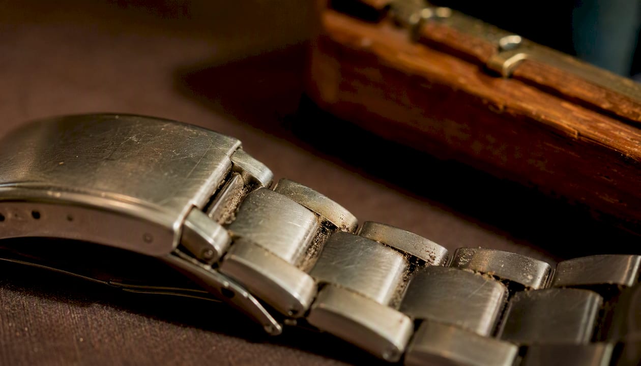 Close-up of grime on metal watch bracelet