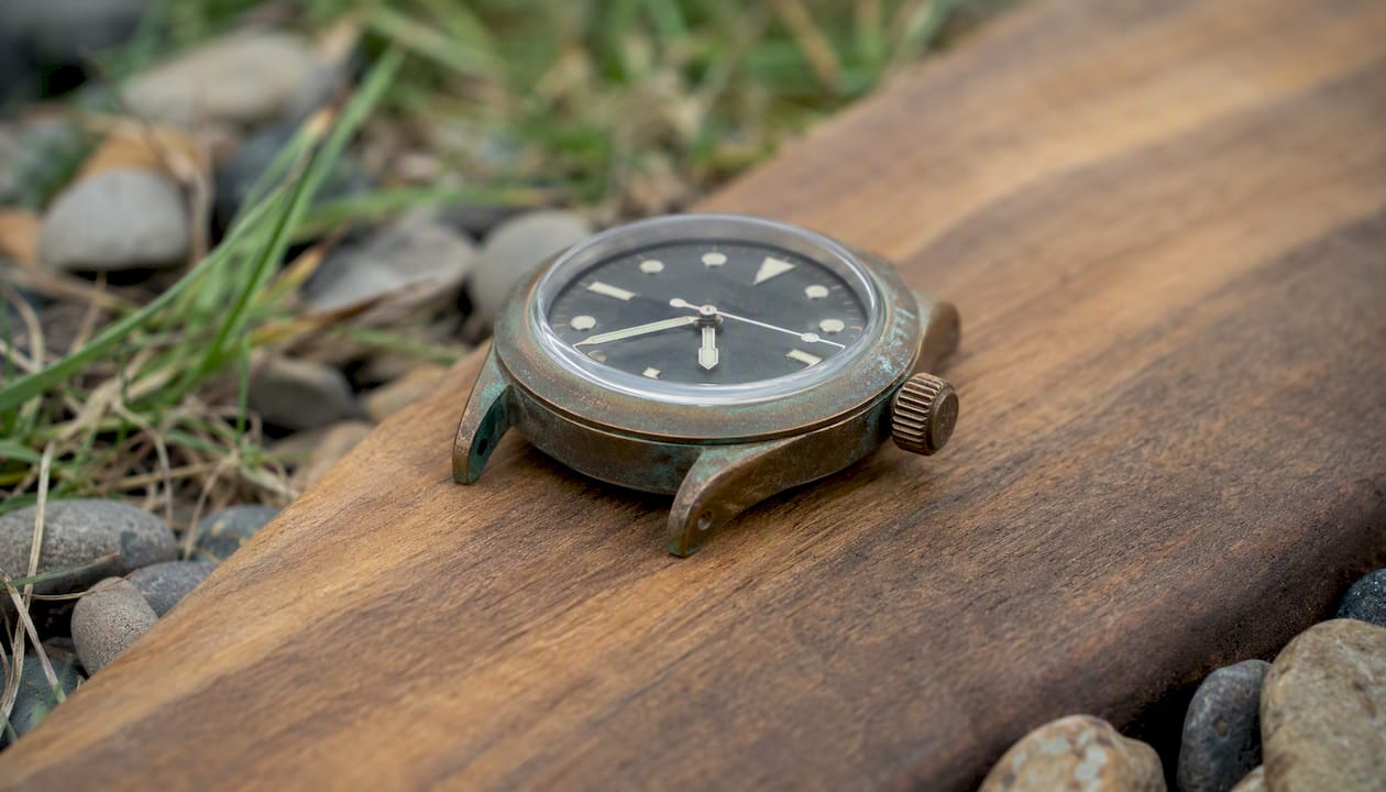 Bronze watch case with patina on stone