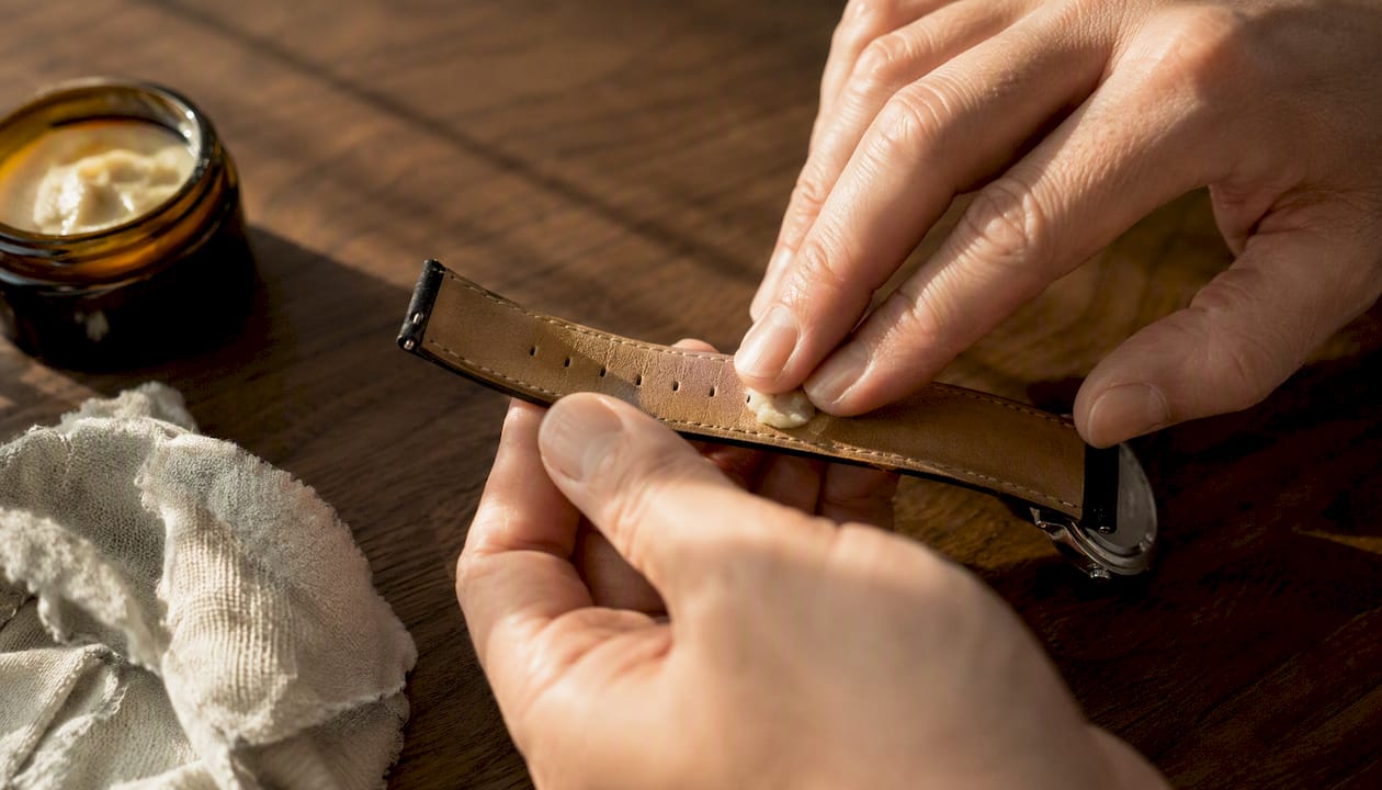 Applying conditioner to underside of leather watch strap