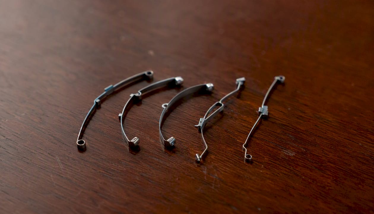 Different designs of watch click springs
