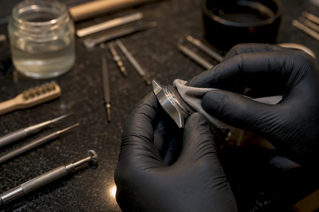 Hands polishing a titanium watch case