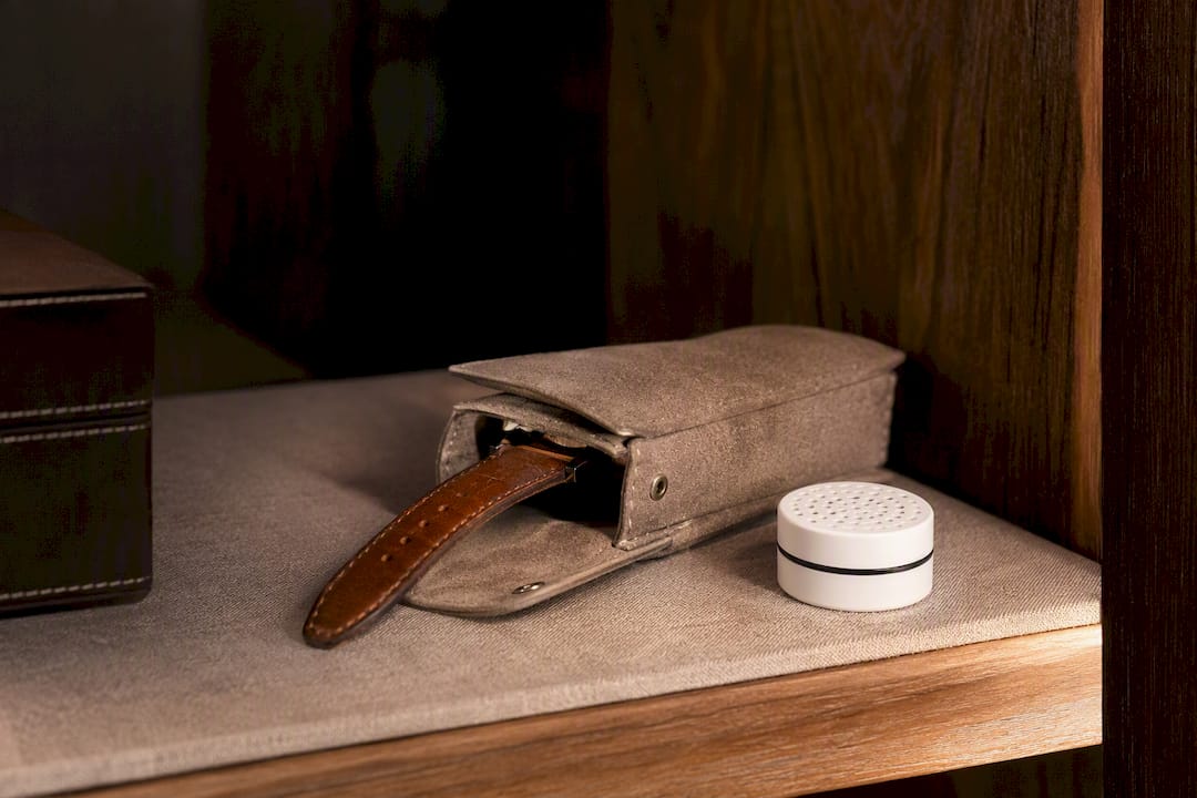 Leather watch strap resting in storage pouch