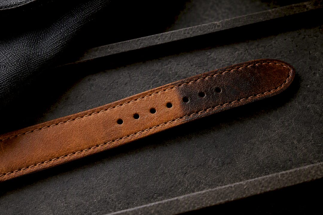 Leather strap showing patina and fragrance discoloration