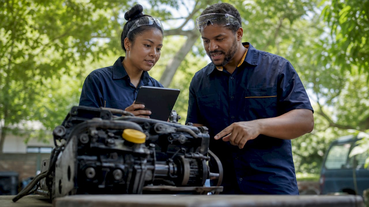 Technicians discussing engine warranty details