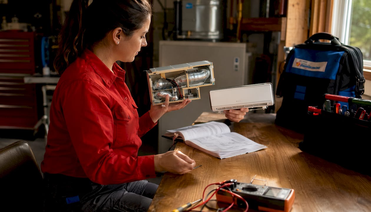 Technician comparing HVAC system components