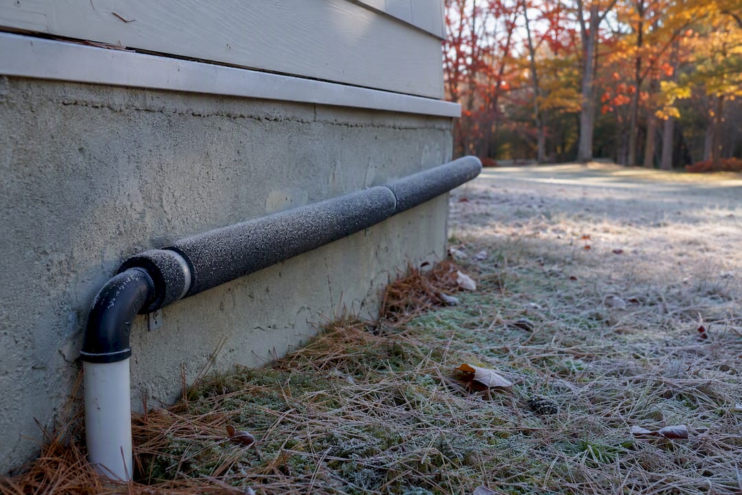 Insulated sump pump discharge pipe outdoors
