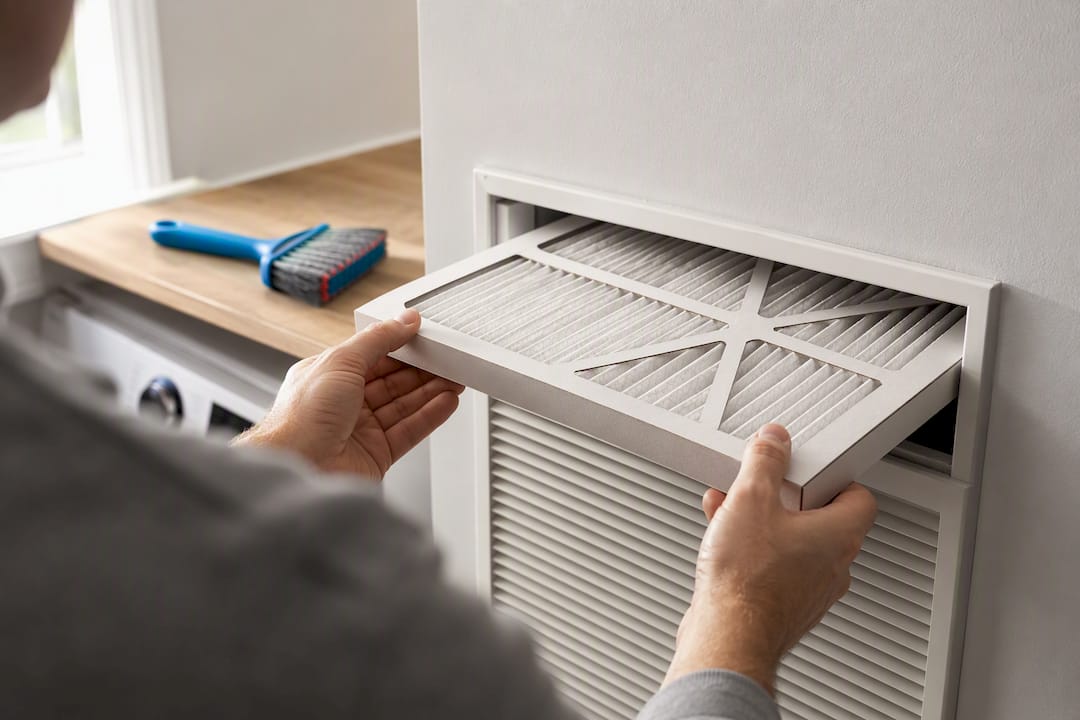 Homeowner checking HVAC air filter