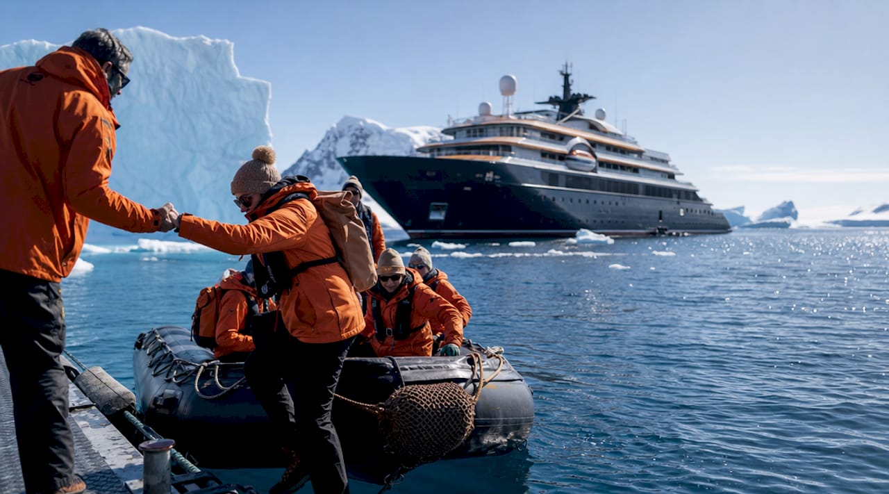 Luxury expedition ship among Antarctic icebergs
