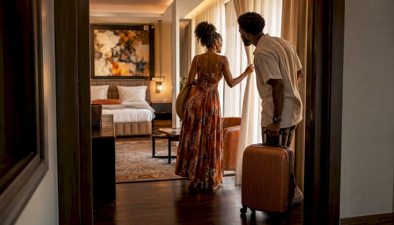 Couple entering one-bedroom suite with separate rooms