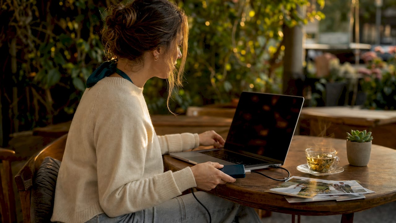 Woman backing up wedding photos on laptop