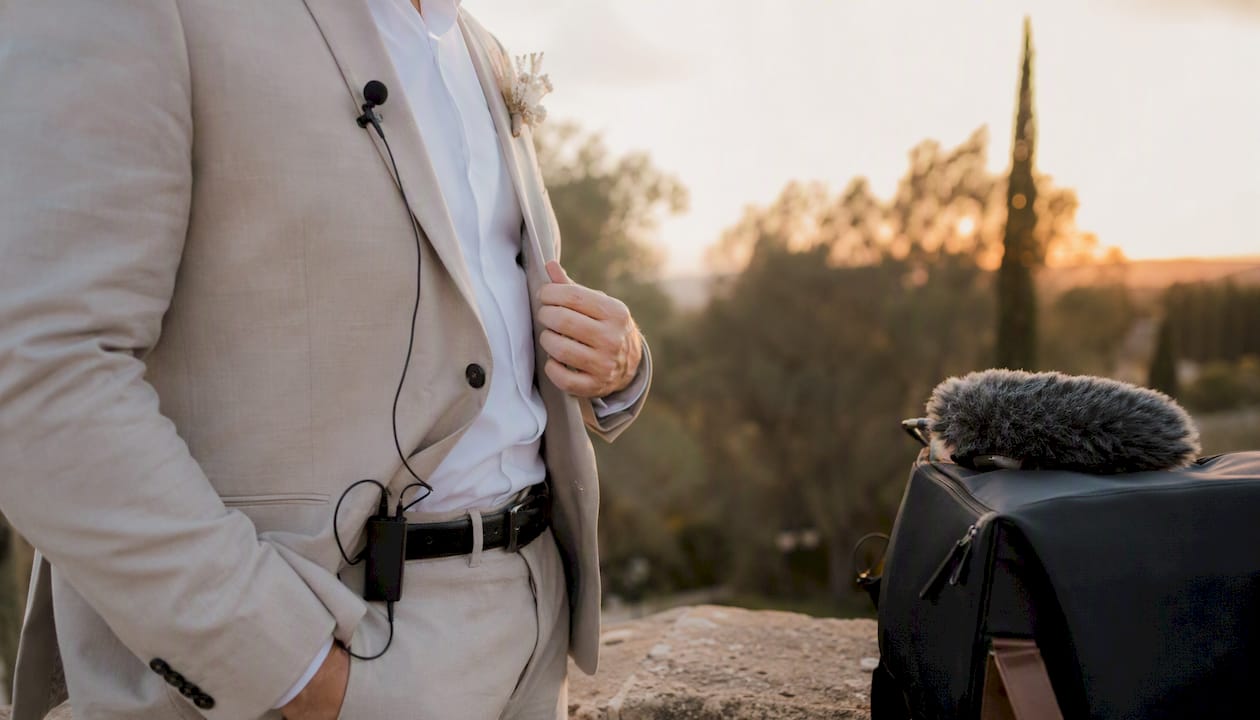 Wireless microphone with windscreen on groom's suit