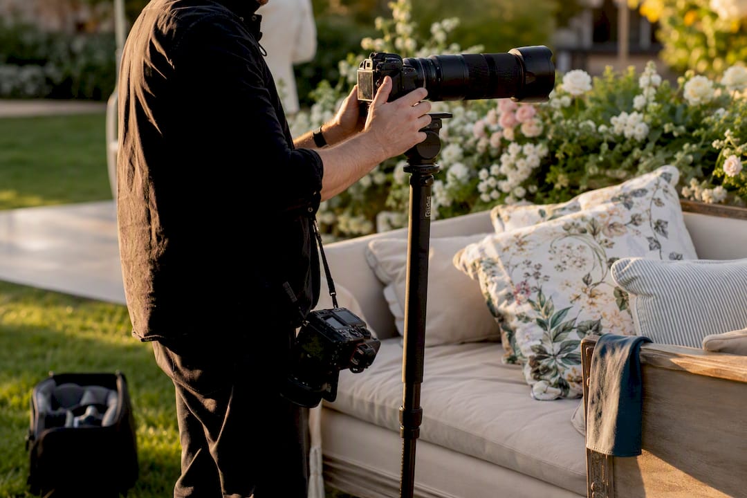 Second shooter adjusting camera gear