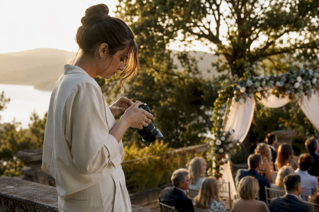 Photographer adjusting camera in wedding ceremony