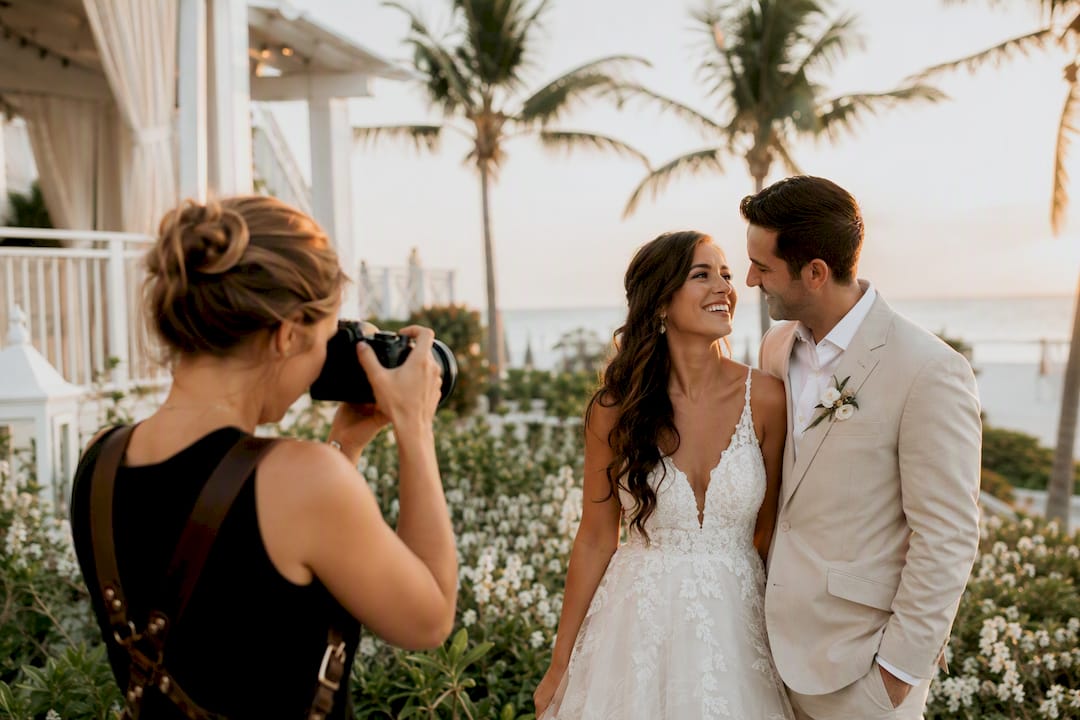 Photographer capturing couple at golden hour