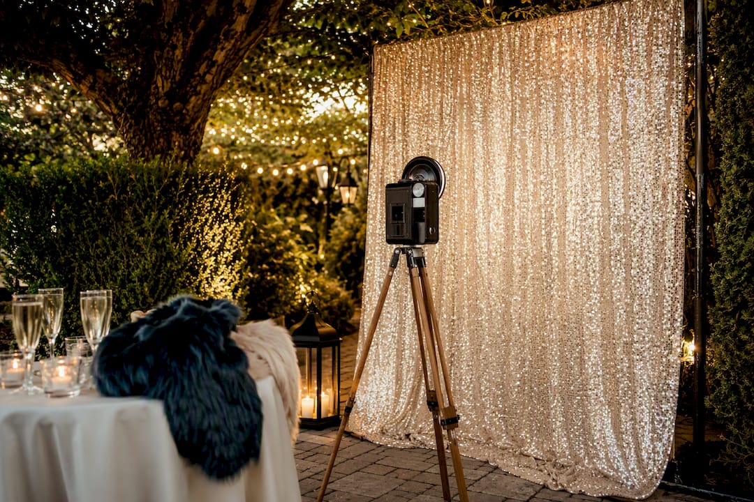 Glam photo booth setup with lighting and props