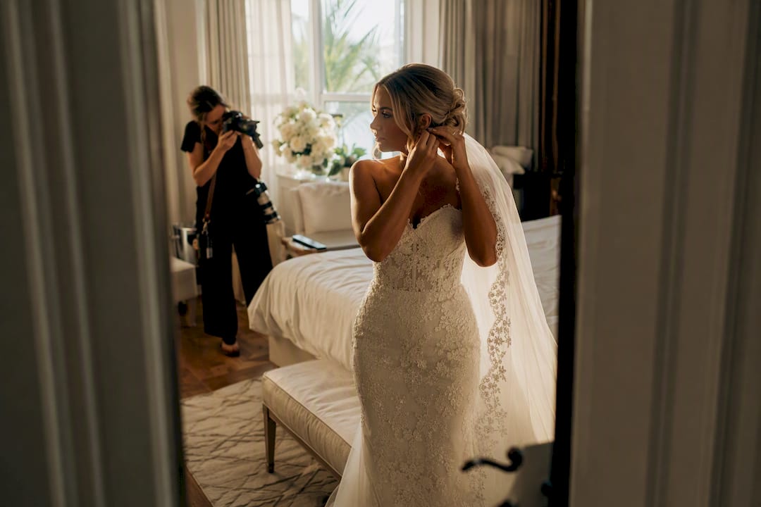 Photographer documenting bride before wedding ceremony