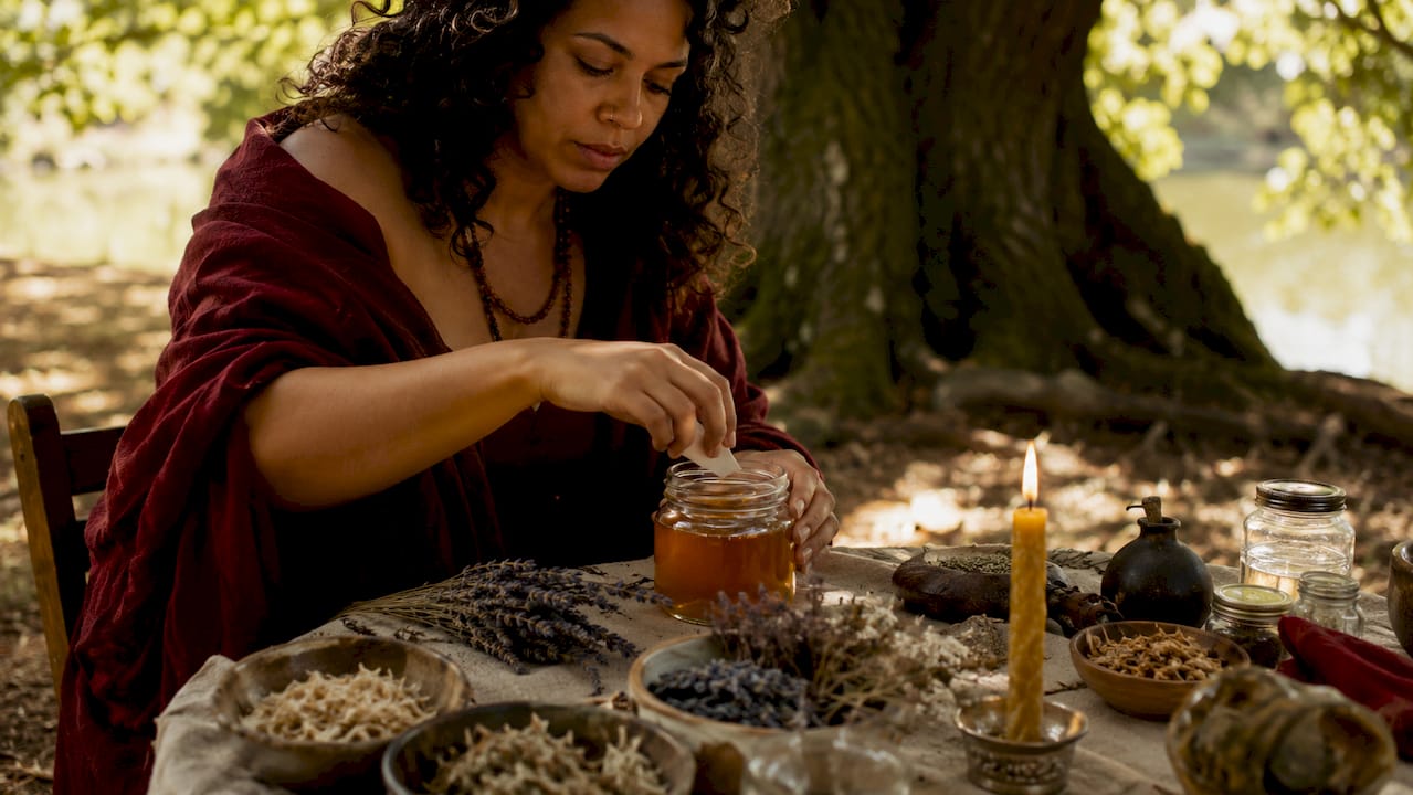 Close-up of hands preparing honey jar spell
