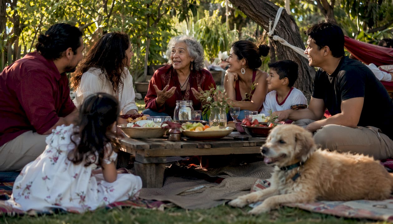 Family group sharing stories at reunion in living room