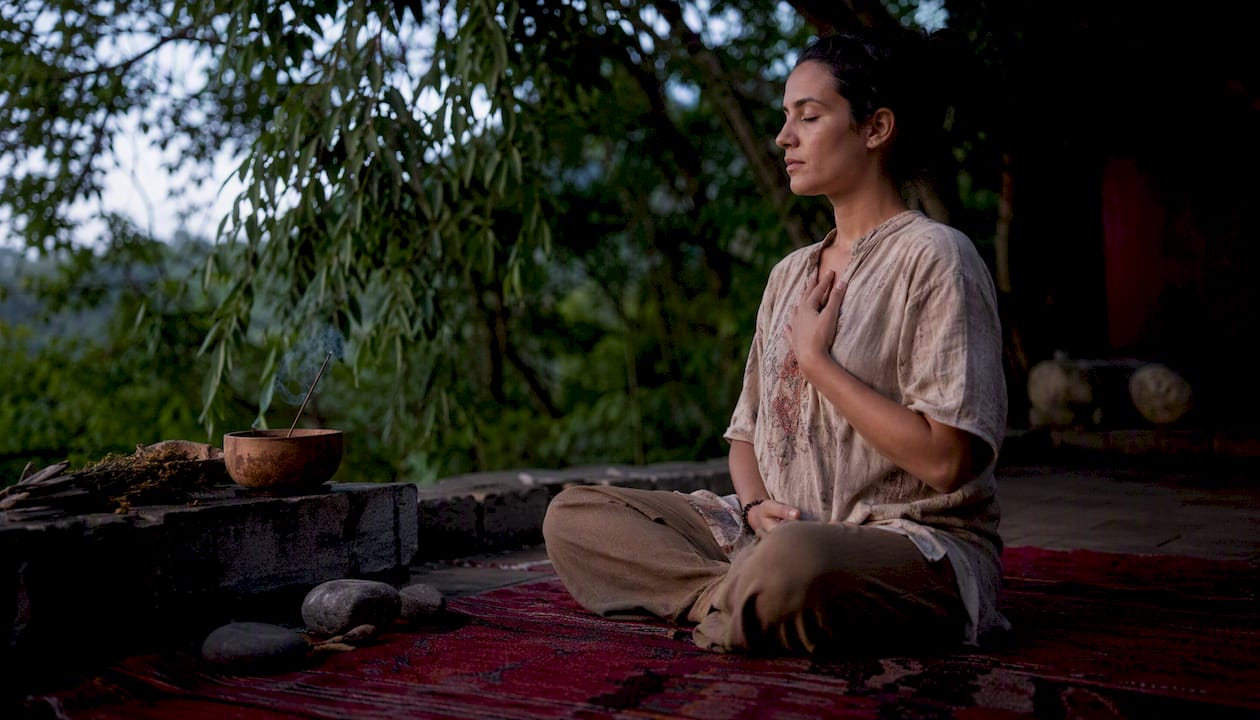 Meditative person grounding with hand on chest